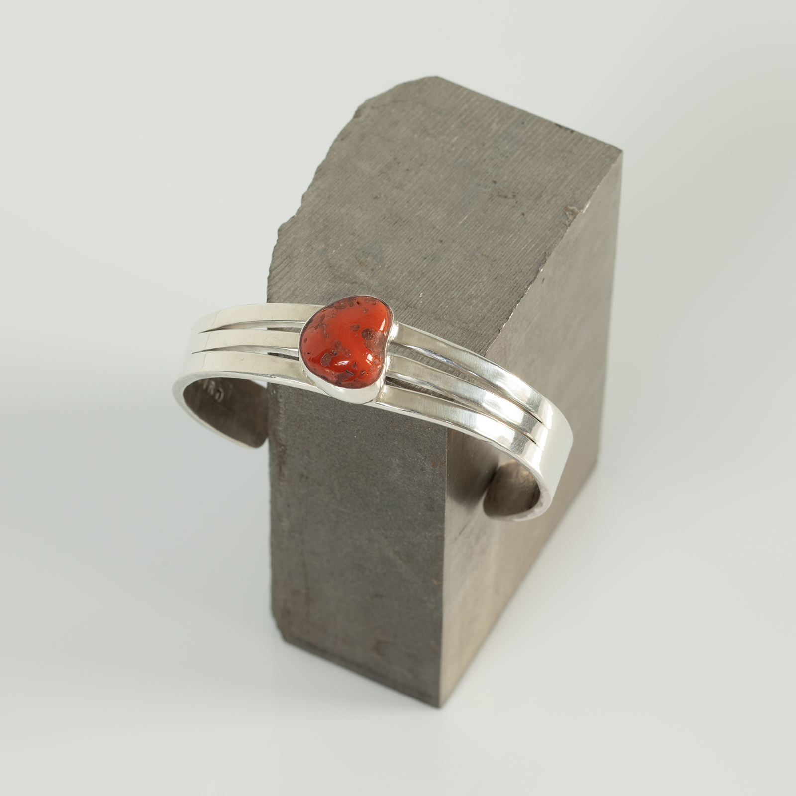 Coral cuff on titanium block.