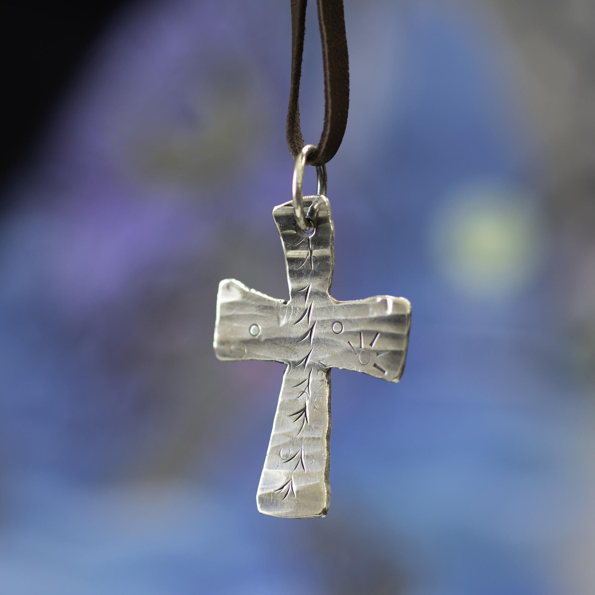 Cross pendant on blue background.