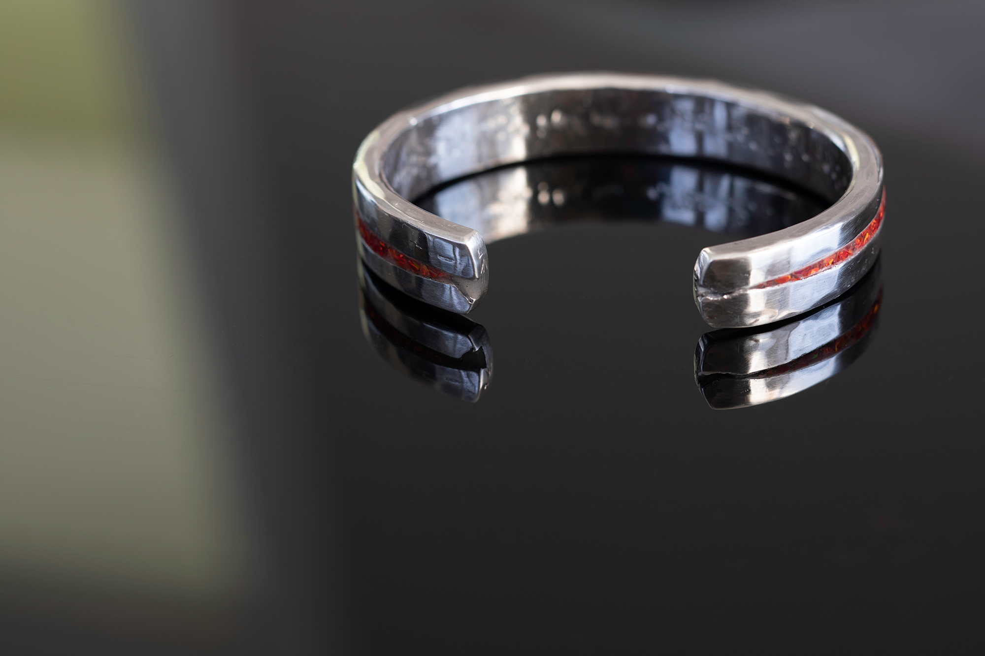 Opal cuff on dark tabletop.