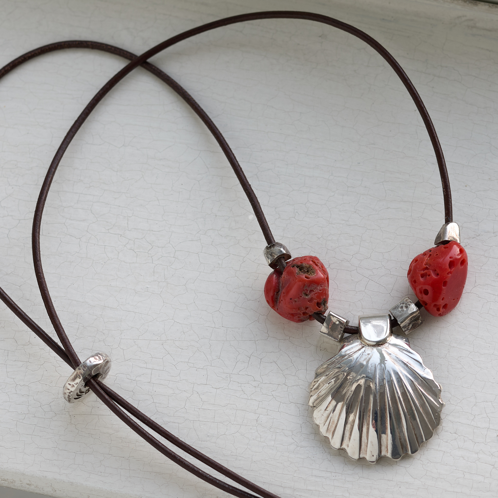 Silver shell on white window sill.